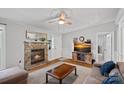 Inviting living room features a stone fireplace and TV and a comfortable sofa set at 2934 Drakes Crossing Dr, Charlotte, NC 28262