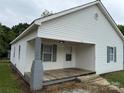 Side view of a charming single-story home with a wooden front porch and gray painted brick column at 303 Southern Ave, East Spencer, NC 28039