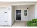 Close-up of the front door with a black door and white trim around the door and siding at 3349 Ellingford Rd, Charlotte, NC 28214