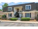 Charming townhome featuring classic brick facade, covered balconies, and well-manicured landscaping at 3520 Colony Rd # D, Charlotte, NC 28211