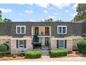 Charming townhome featuring classic brick facade, covered balconies, and well-manicured landscaping at 3520 Colony Rd # D, Charlotte, NC 28211