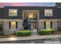 Charming townhome featuring classic brick facade, covered balconies, and well-manicured landscaping at 3520 Colony Rd # D, Charlotte, NC 28211