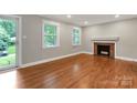 Bright living room boasts hardwood floors, a cozy fireplace, and large windows at 3624 Moultrie St, Charlotte, NC 28209