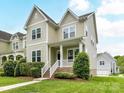 Two-story home with white trim, covered front porch, green lawn, and manicured shrubbery at 4732 Water Oak Rd, Charlotte, NC 28211