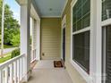 Covered front porch showcasing white columns, blue ceiling, and a view of the neighborhood street at 4732 Water Oak Rd, Charlotte, NC 28211