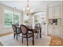 Bright dining room with chandelier and large window views at 5805 Copperleaf Commons Ct, Charlotte, NC 28277
