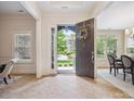 Open foyer with stone doorway view and light tile floors at 5805 Copperleaf Commons Ct, Charlotte, NC 28277