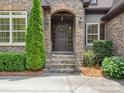 Close up of stone accented entryway with a decorative wreath at 5805 Copperleaf Commons Ct, Charlotte, NC 28277