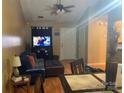 Cozy living room with comfortable seating, television, ceiling fan, and natural light at 5816 Rocky Mount Ct, Charlotte, NC 28214