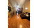 Spacious living room featuring hardwood floors and natural light from dining area doors at 5816 Rocky Mount Ct, Charlotte, NC 28214