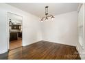 Dining room with modern lighting fixture and open access to the kitchen at 5926 Sharon Rd, Charlotte, NC 28210