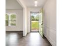 Bright foyer with dark wood floors and a green front door at 5926 Sharon Rd, Charlotte, NC 28210