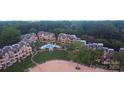 Aerial view of condo complex with pool, greenery, and lake access at 635 Portside Dr, Davidson, NC 28036