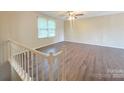 Spacious living area with luxury vinyl floors, large windows, and a ceiling fan at 7021 Willow Bend Ln, Mint Hill, NC 28227