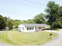 Cozy single-story home with a convenient carport and manicured lawn at 8095 New St, Mount Pleasant, NC 28124