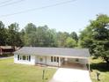 Well-maintained single-story house with a covered carport and mature trees at 8095 New St, Mount Pleasant, NC 28124