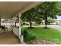 View from the cozy front porch showcasing the well-manicured lawn and neighborhood street at 8808 Palmutum Pl, Charlotte, NC 28269
