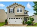 Charming two-story home featuring a two-car garage, well-maintained lawn, and lovely landscaping at 9733 Paper Tree Rd, Charlotte, NC 28227