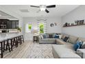 Open-concept living room featuring a comfortable gray sectional sofa, stylish rug, and plenty of natural light at 9733 Paper Tree Rd, Charlotte, NC 28227