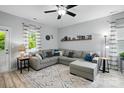 Open-concept living room featuring a comfortable gray sectional sofa, stylish rug, and plenty of natural light at 9733 Paper Tree Rd, Charlotte, NC 28227