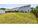 Spacious fenced backyard featuring a patio with furniture and ample green space at 1022 Hinson Forest Rd, Monroe, NC 28110