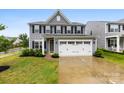 Charming two-story home features a manicured lawn and a two-car garage at 1022 Hinson Forest Rd, Monroe, NC 28110