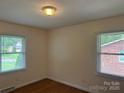 Bedroom with hardwood floors, window, and neutral paint provides a cozy atmosphere at 1115 Dumbarton Rd, Gastonia, NC 28054