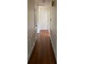 Hallway features hardwood floors, white trim and moulding, and classic doors and hardware at 1115 Dumbarton Rd, Gastonia, NC 28054