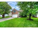 Charming two-story brick home with a well-manicured lawn and attached two-car garage at 116 Amber Woods Dr, Tega Cay, SC 29708