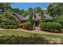 Traditional brick home showcasing a well-manicured lawn and a brick walkway at 118 Tayport Dr, Troutman, NC 28166