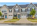 Charming townhome exterior featuring a well-manicured lawn, attached garage, and classic architectural details at 124 Kristin View Ln # C, Troutman, NC 28166