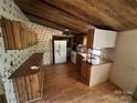 Functional kitchen with wooden cabinets, laminate flooring and appliances at 1399 Branton Dr, Iron Station, NC 28080