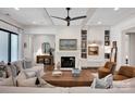 Bright living room featuring coffered ceiling, hardwood floors, a fireplace, and built-in shelving at 14105 Ryker Way, Davidson, NC 28036