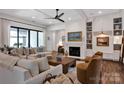 Bright living room featuring coffered ceiling, hardwood floors, a fireplace, and access to the exterior at 14105 Ryker Way, Davidson, NC 28036