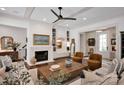 Cozy living room with a fireplace, built-in shelves, hardwood floors, and comfortable seating at 14105 Ryker Way, Davidson, NC 28036
