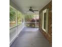 Relaxing covered porch featuring a ceiling fan and charming porch swing at 1619 Bellamy Cir, Albemarle, NC 28001