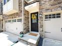 Inviting home entrance with a charming yellow wreath and well-manicured landscaping at 1839 Shumard Ln, Charlotte, NC 28205
