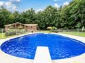 Refreshing in-ground pool with diving board, set against a backdrop of lush greenery at 1878 P L Propst Rd, Maiden, NC 28650