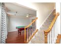 Spacious game room featuring a pool table, hardwood floors, and staircase in view at 2018 Rosewater Ln, Indian Trail, NC 28079