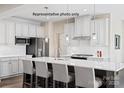 Modern kitchen featuring white cabinets, stainless steel appliances, and a large center island with seating at 2024 Bramble Hedge Rd # 3275, Indian Trail, NC 28079