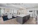 Open-concept kitchen with stainless steel appliances, island, and view of the living room at 2024 Bramble Hedge Rd # 3275, Indian Trail, NC 28079
