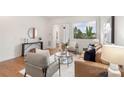 Bright living room with hardwood floors, neutral decor, and balcony access offers comfortable seating and a modern aesthetic at 2653 Shenandoah Ave, Charlotte, NC 28205