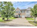 Inviting two-story townhouse with a well-maintained lawn, teal door and blue shutters at 2840 Hopeton Ct, Monroe, NC 28110
