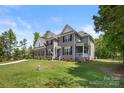 Landscaped front yard of a two-story home featuring a blend of brick and gray siding at 3011 Waxhaw Crossing Dr, Waxhaw, NC 28173