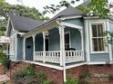 Inviting home with a charming covered porch and brick foundation at 308 W Monroe St, Salisbury, NC 28144
