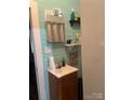 Cozy bathroom featuring a vanity with storage and horizontally paneled teal walls at 325 N Caldwell Ave, Newton, NC 28658