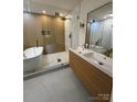 Modern bathroom featuring glass shower, soaking tub, double vanity, and contemporary fixtures at 3326 Winterfield Pl, Charlotte, NC 28205