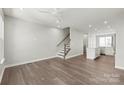 Open-concept living room with hardwood floors, recessed lighting, and staircase access at 420 E 16Th St, Charlotte, NC 28206