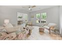Bright living room with a ceiling fan, natural light, and view into dining area at 4633 Cringle Ct, Charlotte, NC 28226