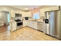 Well-appointed kitchen featuring stainless steel appliances, granite counters, and ample cabinet space at 7133 Tall Tree Ln, Charlotte, NC 28214